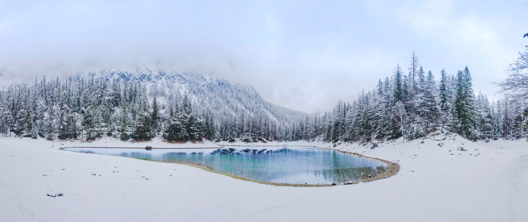 Amazing winter landscape with snowy mountains and clear waters of Green lake (Gruner see), famous tourist destination in Styria region, Austria